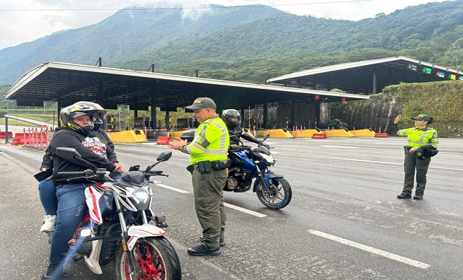 Dos policías de tránsito realizando control a motos en la vía